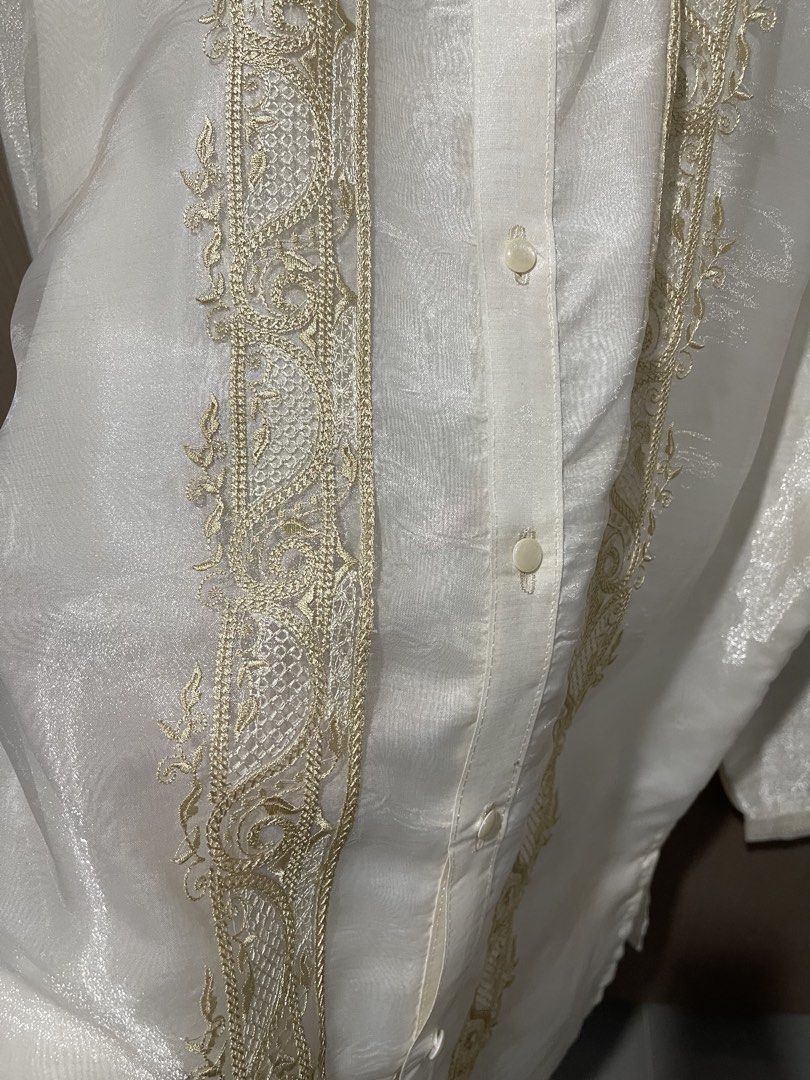 Embroidered Barong Tagalog (Category: Formal Shirts) located in Taguig. Submitted by shennelaluuh (Listing ID 1464835440, Image 3). Description: - Style: Traditional Filipino formal shirt (Barong Tagalog) - Color: White with elegant gold-tone front embroidery - Details: Long sleeves, mandarin collar, front button closure, subtle fabric sheen.