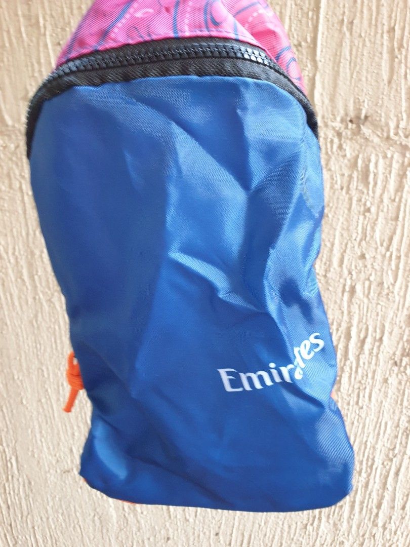 Emirates Airline Multicolored Foldable Travel Backpack (Category: Backpacks) located in Las Pinas. Submitted by anggesmart (Listing ID 1464867738, Image 2). Description: - Official Emirates airline merchandise - Packable design: folds into its own zipped pouch - Eye-catching pink & purple topographic map pattern with airplane icons - Features adjustable black shoulder straps and bright orange side mesh accents - Lightweight and ideal for travel, 