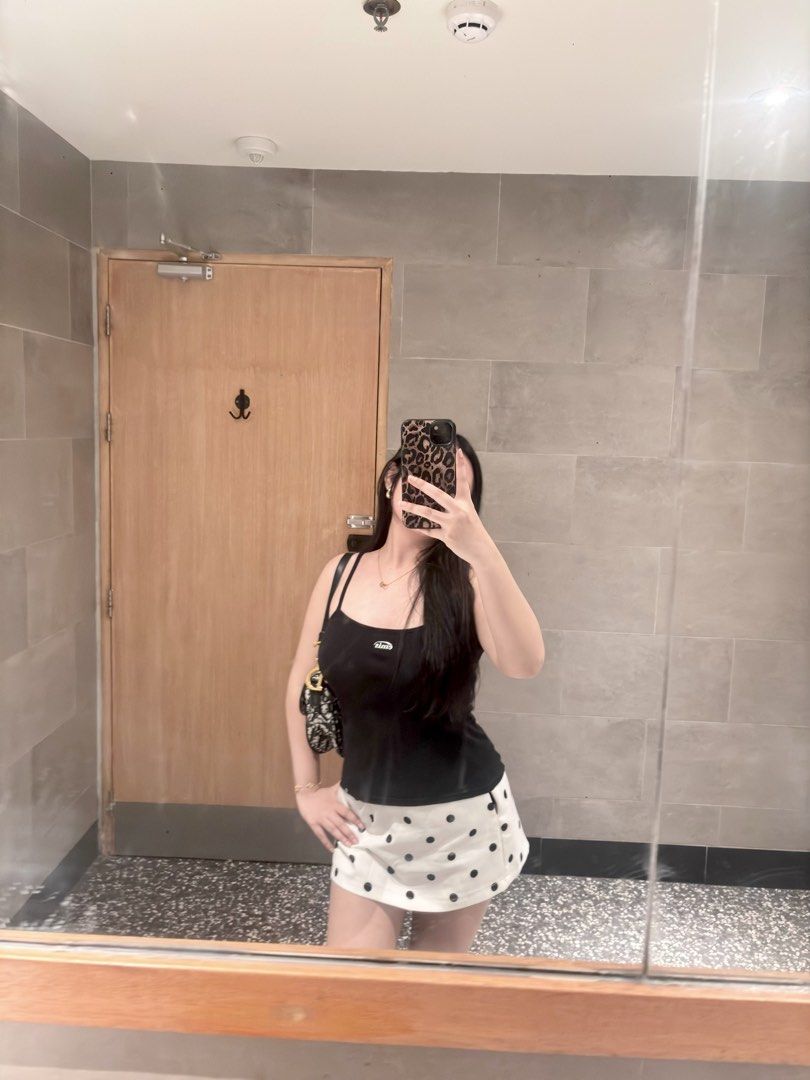 emis black camisole tank top (Category: Sleeveless) located in Manila. Submitted by xoxo_tine (Listing ID 1464791155, Image 3). Description: - Brand: Emis - Color: Black - Style: Slim fit camisole tank top with thin spaghetti straps - Material: Soft and stretchy cotton rib knit - Details: White embroidered Emis logo on the chest and small branded tag on the bottom hem - Versatility: Perfect everyday basic, easy to pair with denim or skirts.