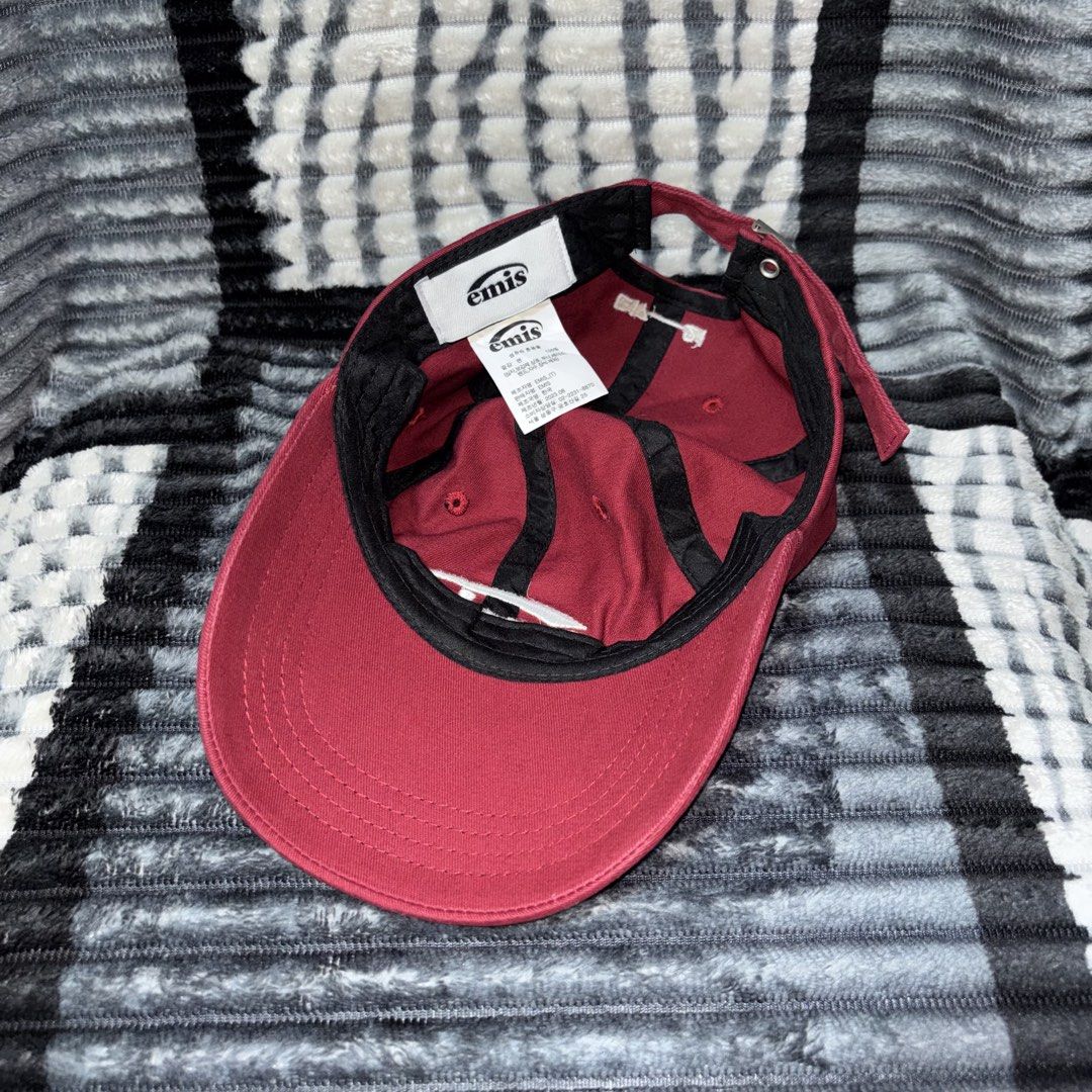 EMIS Burgundy Baseball Cap (Category: Caps & Hats) located in Iligan City. Submitted by 9200rsnl (Listing ID 1464798829, Image 3). Description: - Brand: EMIS - Color: Burgundy with white embroidered logo on the front - Fit: Adjustable strap in the back with a secure metal buckle - Condition: Clean interior lining, excellent overall condition - Authenticity: Inner tags intact, showing a manufacturing date of August 2023.