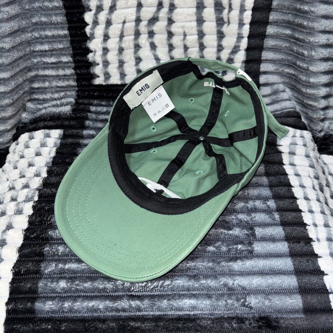EMIS Green Baseball Cap Hat (Category: Caps & Hats) located in Iligan City. Submitted by 9200rsnl (Listing ID 1464798262, Image 3). Description: - Brand: EMIS - Color: Sage Green with white embroidered front logo - Design: Classic six-panel with ventilation eyelets - Details: 'E17-21' stitching above the back strap, interior branded and care tags - Fit: Adjustable metal strap closure - Condition: Clean, excellent, ready to wear.