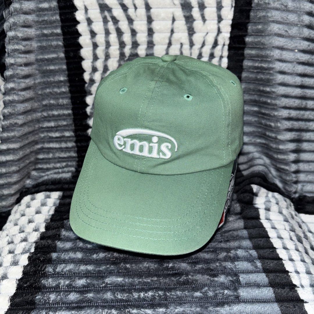 EMIS Green Baseball Cap Hat (Category: Caps & Hats) located in Iligan City. Submitted by 9200rsnl (Listing ID 1464798262, Image 1). Description: - Brand: EMIS - Color: Sage Green with white embroidered front logo - Design: Classic six-panel with ventilation eyelets - Details: 'E17-21' stitching above the back strap, interior branded and care tags - Fit: Adjustable metal strap closure - Condition: Clean, excellent, ready to wear.