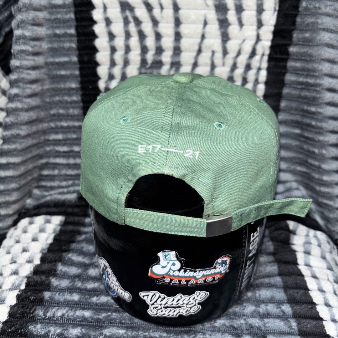 EMIS Green Baseball Cap Hat (Category: Caps & Hats) located in Iligan City. Submitted by 9200rsnl (Listing ID 1464798262, Image 2). Description: - Brand: EMIS - Color: Sage Green with white embroidered front logo - Design: Classic six-panel with ventilation eyelets - Details: 'E17-21' stitching above the back strap, interior branded and care tags - Fit: Adjustable metal strap closure - Condition: Clean, excellent, ready to wear.
