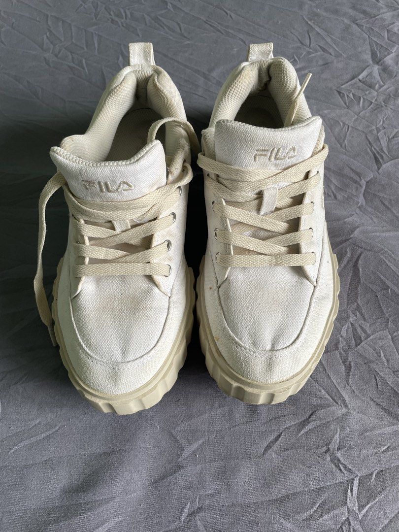 Fila White Platform Sneakers (Category: Sneakers) located in Cagayan de Oro. Submitted by jekdels05 (Listing ID 1464817471, Image 2). Description: - Brand: Fila - Color: Off-white canvas - Style: Chunky platform sneakers with ridged rubber sole - Size: US 6.5 / EUR 39 / UK 5.5 / MM 250 - Features: Regular lace-up, branded tongue, heel pull tab - Origin: Made in Vietnam - Condition: Minor signs of wear on fabric and collar area.