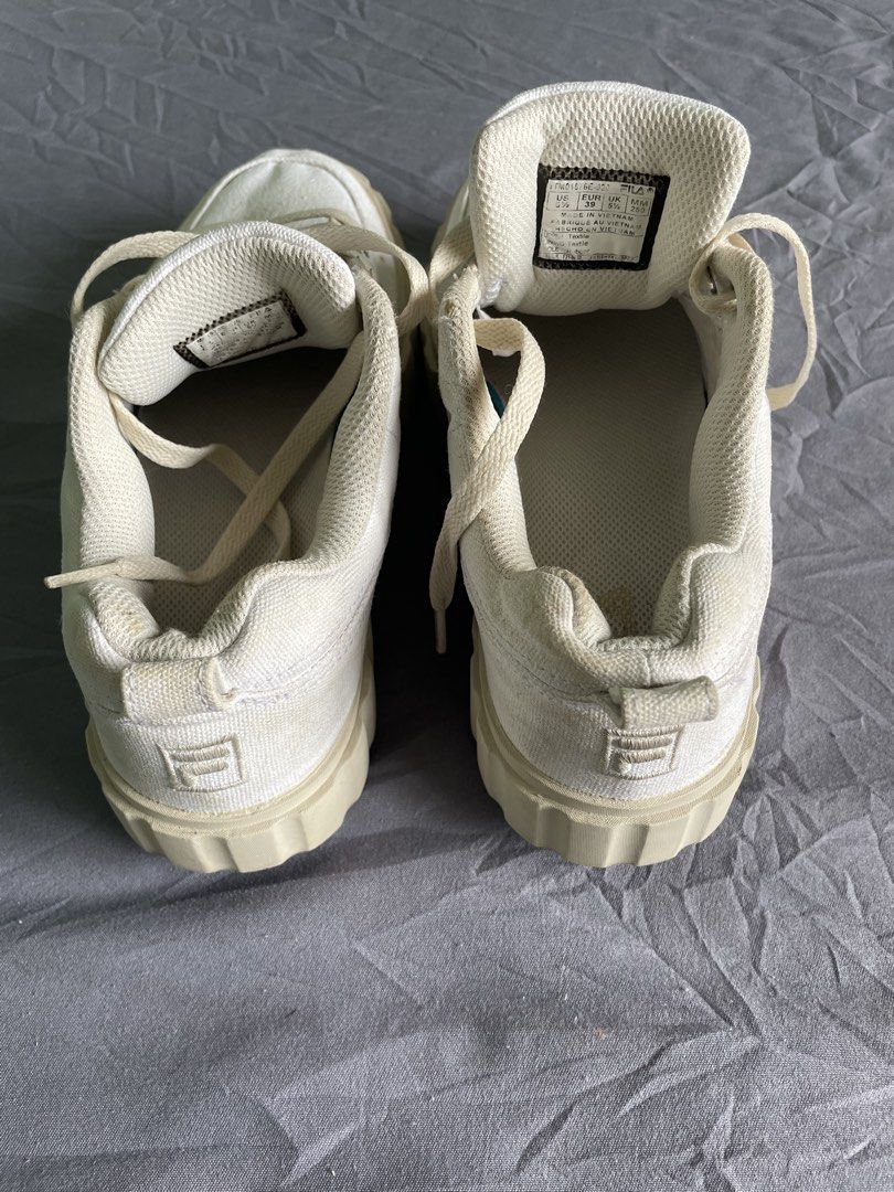 Fila White Platform Sneakers (Category: Sneakers) located in Cagayan de Oro. Submitted by jekdels05 (Listing ID 1464817471, Image 3). Description: - Brand: Fila - Color: Off-white canvas - Style: Chunky platform sneakers with ridged rubber sole - Size: US 6.5 / EUR 39 / UK 5.5 / MM 250 - Features: Regular lace-up, branded tongue, heel pull tab - Origin: Made in Vietnam - Condition: Minor signs of wear on fabric and collar area.