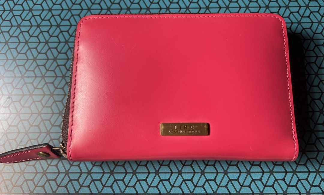 Fino Leatherware Pink Zip Around Wallet (Category: Wallets & Card holders) located in Baguio. Submitted by destashglam (Listing ID 1464792747, Image 1). Description: - Brand: Fino Leatherware - Color: Bright pink - Material: Smooth leather with gold brand plaque - Closure: Secure zip-around - Interior: Multiple card slots and a zipped coin pocket - Exterior: Back stitched slip pocket -medium size - Condition: Minor scuffs from use.