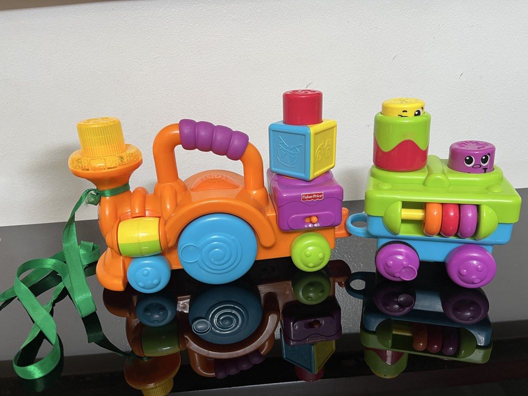 Fisher-Price Laugh & Learn Stacking Train Blocks Set (Category: Educational & Learning Toys) located in Quezon City. Submitted by muffet9 (Listing ID 1464968011, Image 3). Description: - Brand: Fisher-Price - Features: Colorful detachable blocks, sound switches, and lights and music - Design: Orange engine with blue and green carts - Condition: Light and sounds working, fully functional - Perfect for toddler learning and entertainment - bought in