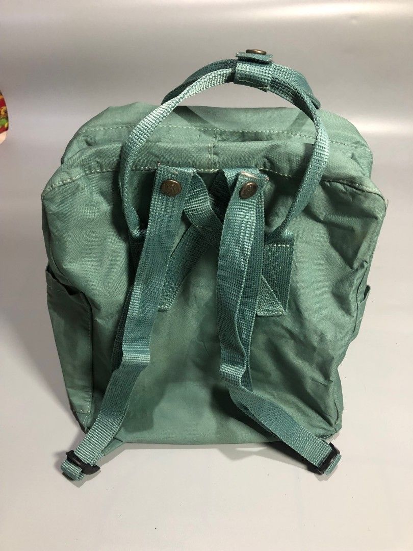 Fjällräven Kånken Backpack Green (Category: Backpacks) located in Manila. Submitted by j_fnds.dvo (Listing ID 1464885593, Image 2). Description: - Authentic Fjällräven Kånken backpack - Color: Muted Green - Classic square design with dual top handles and adjustable shoulder straps - Secure main zipper closure that opens wide for easy packing - Handy front zippered pocket for quick-access items - Features the iconic circular logo patch on the fron