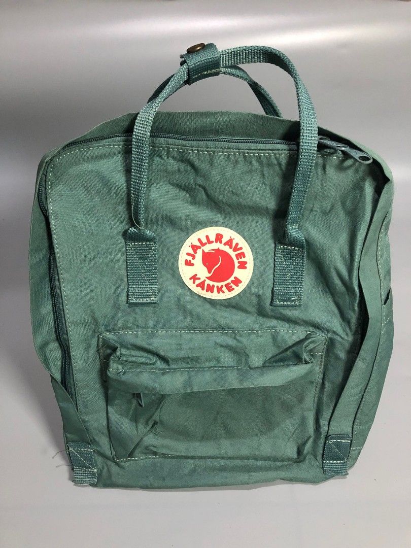 Fjällräven Kånken Backpack Green (Category: Backpacks) located in Manila. Submitted by j_fnds.dvo (Listing ID 1464885593, Image 1). Description: - Authentic Fjällräven Kånken backpack - Color: Muted Green - Classic square design with dual top handles and adjustable shoulder straps - Secure main zipper closure that opens wide for easy packing - Handy front zippered pocket for quick-access items - Features the iconic circular logo patch on the fron
