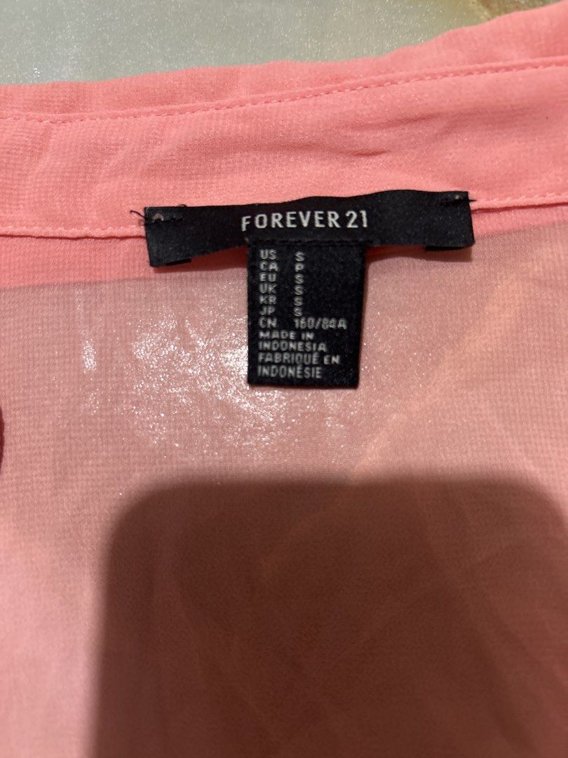 Forever 21 Pink Button-Down Sheer Blouse (Category: Blouses) located in Lal-Lo. Submitted by pureearth_8c747c (Listing ID 1464785184, Image 1). Description: - Brand: Forever 21 - Color: Bright Pink - Size: S - Material: 100% Polyester (Made in Indonesia) - Features: Sheer lightweight fabric, classic collar, two chest pockets, long sleeves with button cuffs - Styling: Great for layering or dressing up and down.