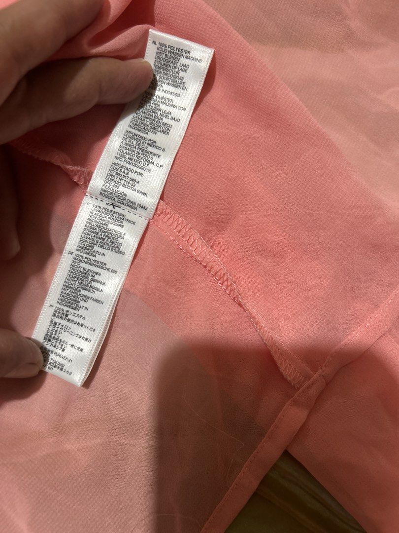 Forever 21 Pink Button-Down Sheer Blouse (Category: Blouses) located in Lal-Lo. Submitted by pureearth_8c747c (Listing ID 1464785184, Image 3). Description: - Brand: Forever 21 - Color: Bright Pink - Size: S - Material: 100% Polyester (Made in Indonesia) - Features: Sheer lightweight fabric, classic collar, two chest pockets, long sleeves with button cuffs - Styling: Great for layering or dressing up and down.