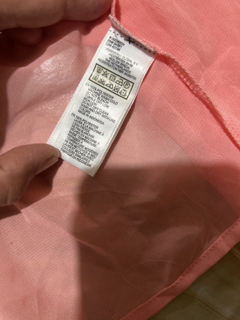 Forever 21 Pink Button-Down Sheer Blouse (Category: Blouses) located in Lal-Lo. Submitted by pureearth_8c747c (Listing ID 1464785184, Image 2). Description: - Brand: Forever 21 - Color: Bright Pink - Size: S - Material: 100% Polyester (Made in Indonesia) - Features: Sheer lightweight fabric, classic collar, two chest pockets, long sleeves with button cuffs - Styling: Great for layering or dressing up and down.