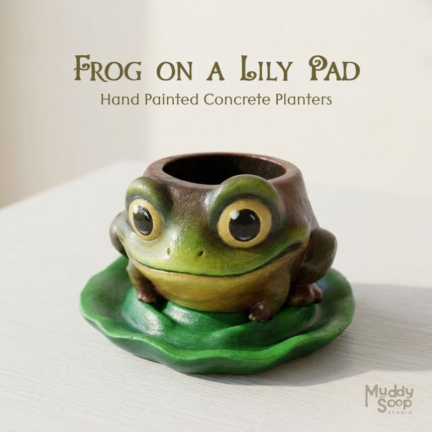 Frog on a Lily Pad Hand Painted Concrete Planter (Category: Pots & Planters) located in Meycauayan. Submitted by muddtree201855 (Listing ID 1464825978, Image 2). Description: Bring a touch of whimsy to your home or garden with this adorable frog-shaped planter. Made from durable concrete and carefully hand-painted with earthy tones, this unique planter features a cheerful frog design perched on a matching lily pad catch plate. Perfect for succule