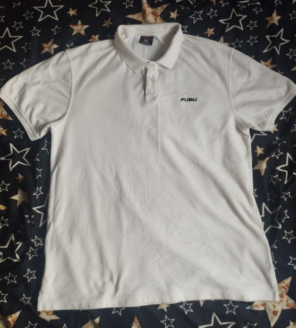 FUBU White Polo Shirt (Category: Tshirts & Polo Shirts ) located in Manila. Submitted by drewzioncl00303 (Listing ID 1464788663, Image 1). Description: - Brand: FUBU - Color: Classic White - Style: Short sleeve polo shirt with standard collar and two-button placket - Detail: Small embroidered FUBU logo on the left chest - Versatility: Clean design, easy to match with jeans or shorts - Condition: Excellent, casual wardrobe staple.