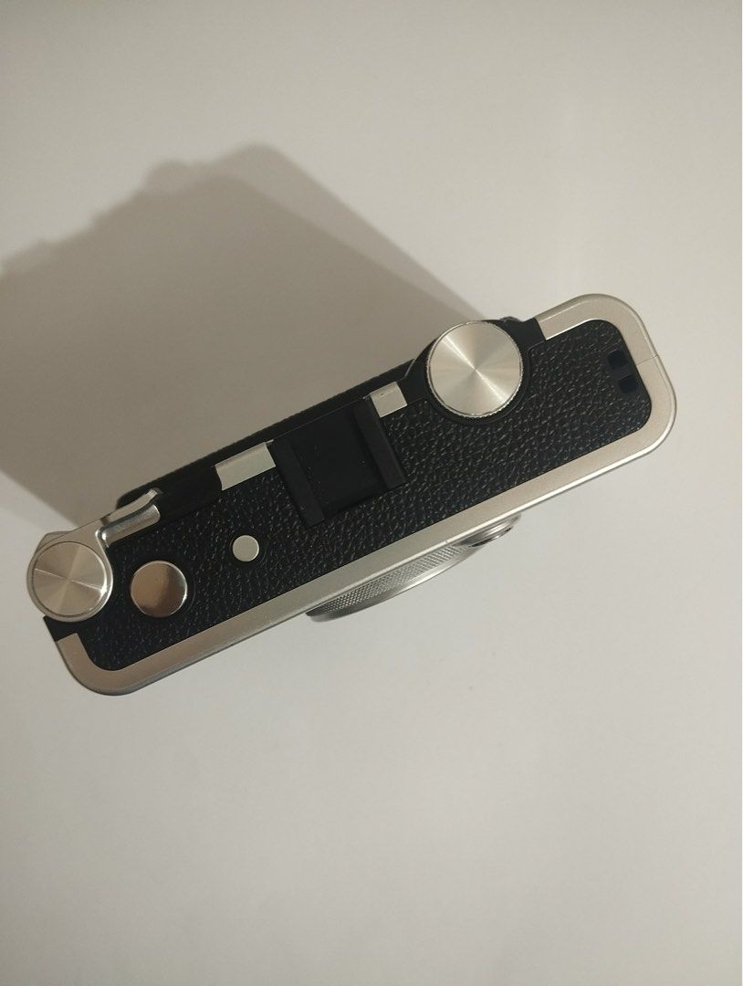 Fujifilm Instax Mini Evo Hybrid Instant Camera (Category: Cameras) located in Tagoloan. Submitted by kethhh (Listing ID 1464797224, Image 2). Description: - Model: Fujifilm Instax Mini Evo (Black & Silver) - Features: Hybrid digital camera with built-in Instax Mini printer and rear LCD screen - Controls: Classic manual dials and levers on top - Inclusions: Original retail box and body as pictured - Condition: Excellent, great for instant photogra