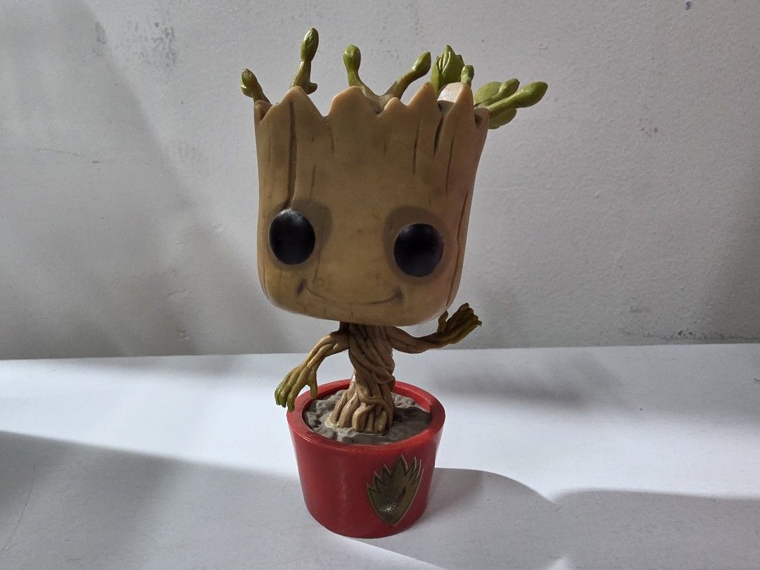 Funko Pop Dancing Groot #65 (Category: Figurines & Statues) located in Manila. Submitted by silienat (Listing ID 1464809820, Image 1). Description: - Character: Baby Groot (Guardians of the Galaxy) - Brand: Funko Pop bobblehead figure - Design: Wooden texture, green sprouts, and front golden Groot logo emblem - Condition: Loose figure, no original box, stands on its own - Perfect addition to your Marvel collection or desk setup - Meetup or shippi