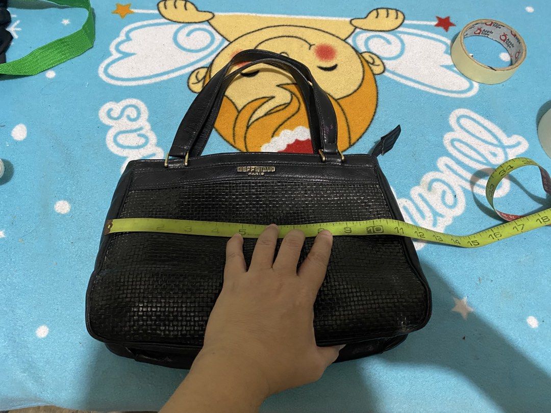 Geffriaud Paris Black Woven Leather Handbag (Category: Luxury Bags & Wallets) located in Manila. Submitted by resi.diaz (Listing ID 1464873335, Image 2). Description: - Brand: Geffriaud Paris - Color: Classic Black - Design: Stylish woven texture detail on the lower front with gold branding stamp - Straps: Dual structured shoulder straps with elegant gold-tone hardware links - Closure: Secure zipper top closure - Condition: Excellent/Well-maintai