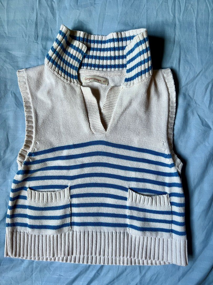 Gingersnaps Blue and White Striped Knitted Collared Top (Category: Babies & Kids Fashion) located in Rosario. Submitted by yazah.shop (Listing ID 1464773221, Image 3). Description: - Size: 8Y, fits 4-6y/o - Color: Cream with blue stripes - Style: Sleeveless vest, v-neck polo collar, two front patch pockets - Details: Ribbed hem and collar, soft knit fabric - Condition: Great for layering or wearing on its own.
