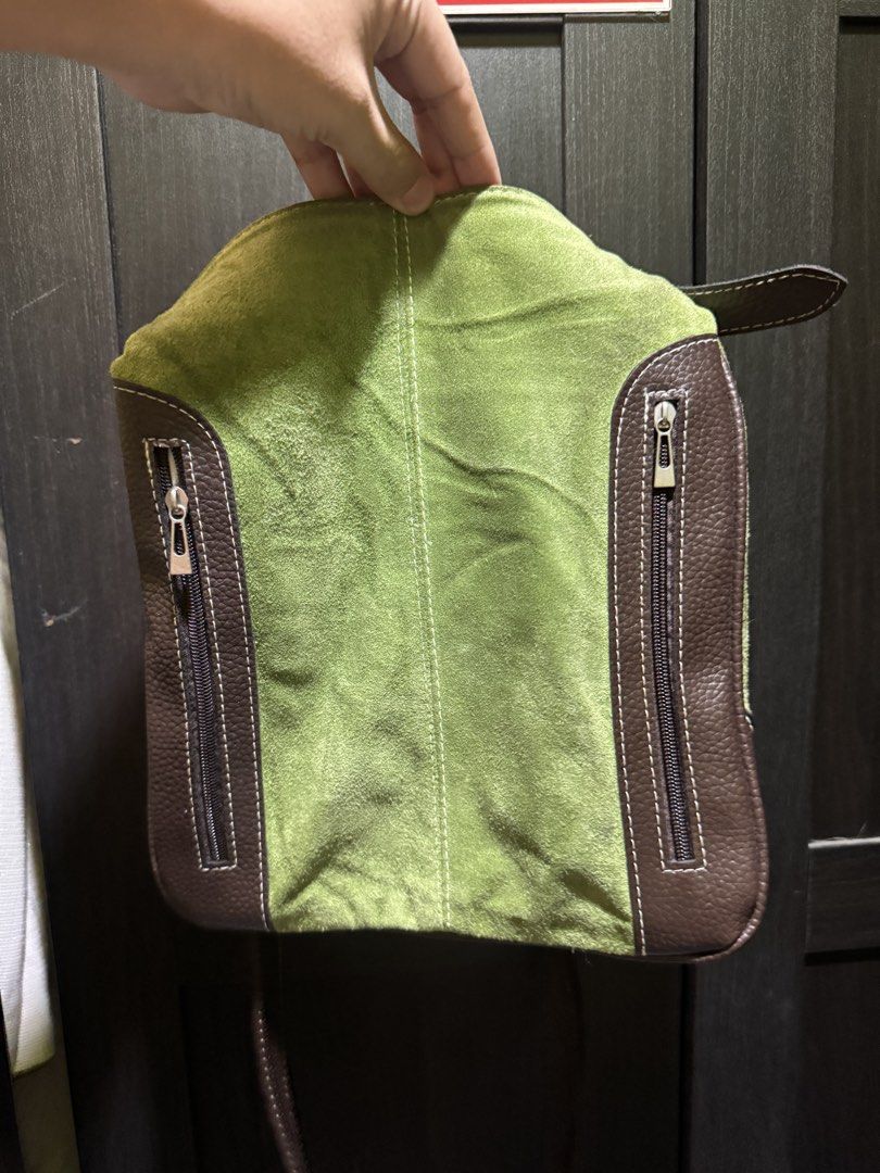 Green and Brown Suede Leather Shoulder Bag (Category: Shoulder Bags) located in Manila. Submitted by pierce_120 (Listing ID 1464862733, Image 1). Description: - Color & Material: Green suede body with contrast brown leather trim - Pockets: Two vertical front zippered pockets for easy access - Hardware: Sleek silver-tone hardware throughout - Strap: Removable brown leather shoulder straps with metal ring attachments - Size: Compact design, perfect