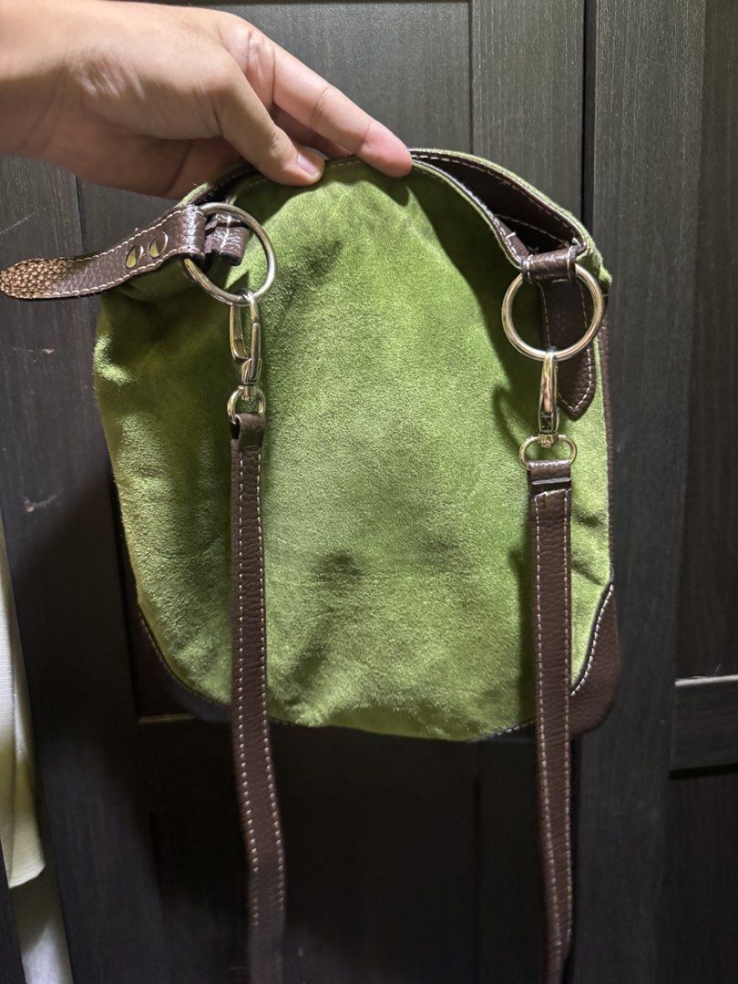 Green and Brown Suede Leather Shoulder Bag (Category: Shoulder Bags) located in Manila. Submitted by pierce_120 (Listing ID 1464862733, Image 2). Description: - Color & Material: Green suede body with contrast brown leather trim - Pockets: Two vertical front zippered pockets for easy access - Hardware: Sleek silver-tone hardware throughout - Strap: Removable brown leather shoulder straps with metal ring attachments - Size: Compact design, perfect