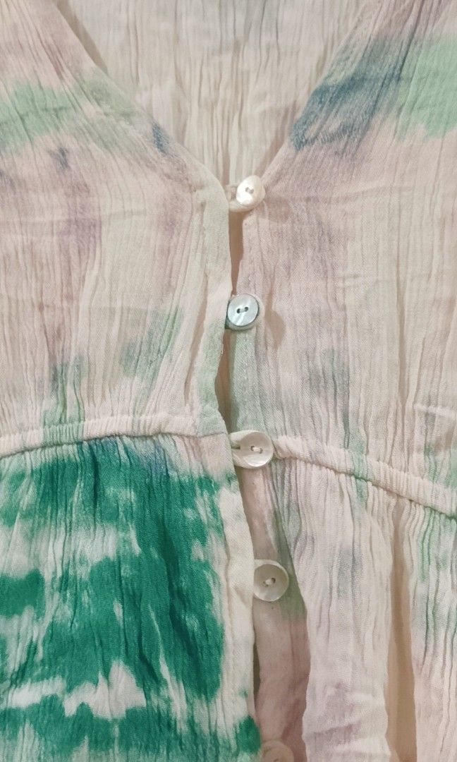 Green and white tie-dye crop blouse from Pull&Bear (Category: Blouses) located in Cabanatuan. Submitted by miss.maia (Listing ID 1464947649, Image 3). Description: The image shows a green and white tie-dye crop blouse from Pull&Bear featuring a deep V-neck, front button closure, and short ruffled sleeves..