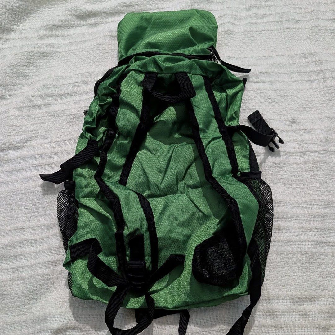 Green Foldable Packable Lightweight Daypack Travel Backpack (Category: Hiking & Camping) located in Iba. Submitted by leovincee.1414 (Listing ID 1464796790, Image 2). Description: - Color: Green - Material: Lightweight ripstop - Design: Folds completely flat into its own compact pouch - Features: Mesh side pockets, adjustable shoulder straps, and front zip pocket - Ideal for: Hiking, cycling, and travel.
