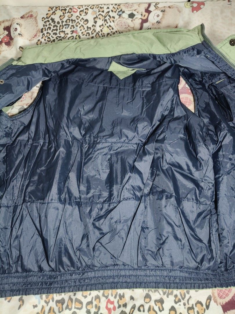 Green Utility Puffer Jacket Vest (Category: Coats, Jackets and Outerwear) located in Lapu Lapu. Submitted by hooman422 (Listing ID 1464914709, Image 3). Description: • Style: Multi-pocket utility or tactical gilet vest. • Color: Light sage green or olive drab. • Material: Lightweight, durable synthetic nylon or polyester fabric. • Closure: Front zipper closure with a buttoned storm flap. • Collar: High stand-up mock neck collar. • Pockets: Featur