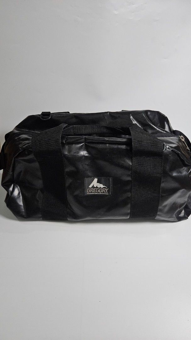 Gregory Black Duffle Bag (Category: Backpacks) located in Alfonso. Submitted by jbcamet (Listing ID 1464909583, Image 1). Description: - Brand: Gregory - Color: Sleek black with a glossy, weather-resistant finish - Compartment: Spacious main compartment with fully lined interior - Hardware: Heavy-duty YKK zippers with convenient pull cords - Portability: Dual carry handles with a secure snap wrap handle - Versatility: Ideal for daily gym sessions