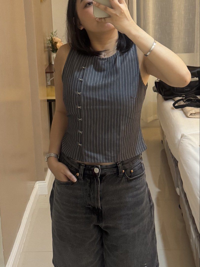 Grey Pinstripe Sleeveless Top (Category: Sleeveless) located in Paranaque City. Submitted by maedizon (Listing ID 1464869527, Image 1). Description: - Color & Pattern: Grey with all-over white pinstripes - Fit: Fitted cut, sits right at the waist - Details: Unique button closure running down the front right side - Condition: Worn once, still in great shape .
