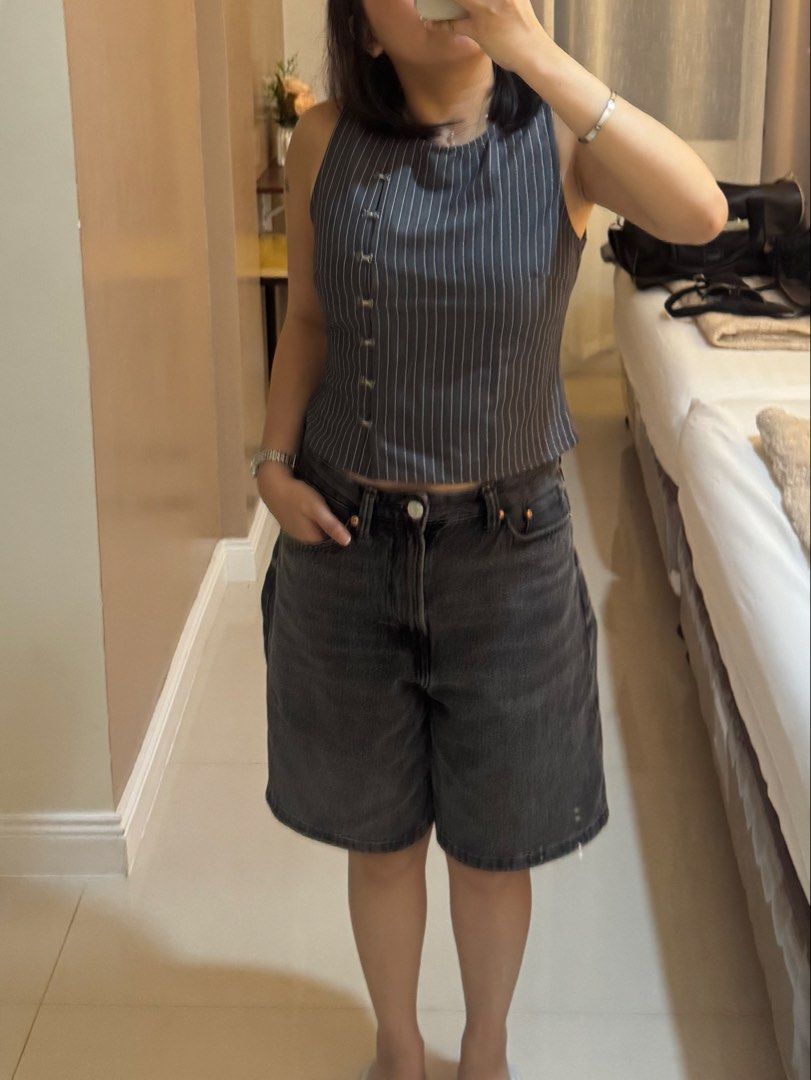 Grey Pinstripe Sleeveless Top (Category: Sleeveless) located in Paranaque City. Submitted by maedizon (Listing ID 1464869527, Image 2). Description: - Color & Pattern: Grey with all-over white pinstripes - Fit: Fitted cut, sits right at the waist - Details: Unique button closure running down the front right side - Condition: Worn once, still in great shape .