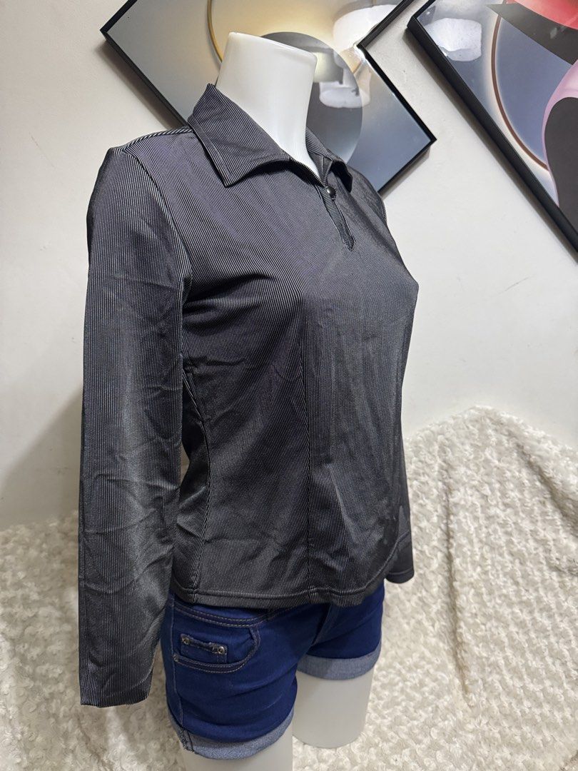 Grey Striped Long Sleeve Polo Blouse (Category: Longsleeves) located in Marikina City. Submitted by lorradel (Listing ID 1464902344, Image 2). Description: - Colour/Pattern: Grey and black pinstripe - Fit: Fitted silhouette through the torso - Material: Lightweight ribbed fabric with great stretch - Details: Collared neckline, single front button closure, and back yoke - Styling: Excellent layering piece for casual or smart-casual outfits - MAY H