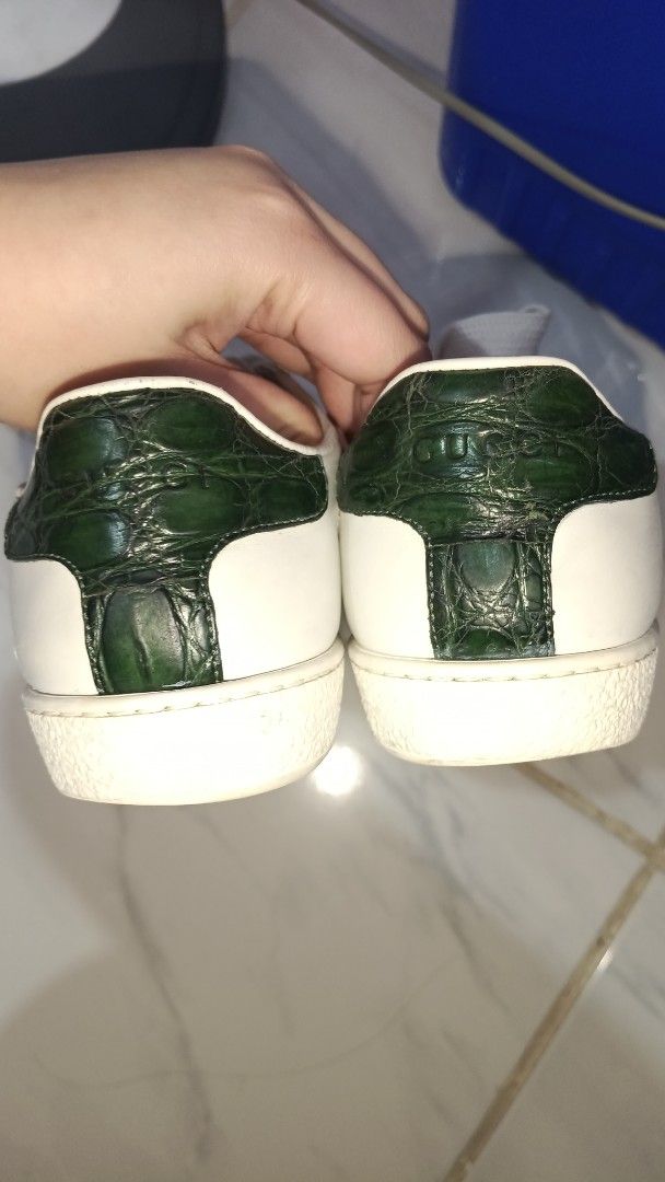 Gucci Ace Leather Sneaker White Green Red (Category: Sneakers) located in Manila. Submitted by ysabelgale09807 (Listing ID 1464802814, Image 2). Description: - Brand: Gucci - Style: Classic white leather sneakers with green and red web stripe - Details: Textured dark green heel patch with embossed Gucci lettering, thick white laces, and rubber soles - Condition: General wear on the white leather upper and soles, clean insoles with faint branding 