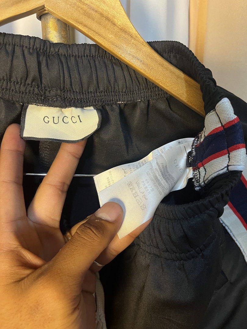 Gucci Black Track Shorts with Side Stripe (Category: Shorts) located in Kidapawan. Submitted by azythrift (Listing ID 1464916041, Image 3). Description: - Authentic Gucci shorts made in Italy - Color: Black with signature red, blue, and white side stripes featuring GG logo details - Waistband: Comfortable white drawstring - Fit: Relaxed fit, perfect for stylish casual streetwear - Condition: Includes original interior brand tag and care labels - 