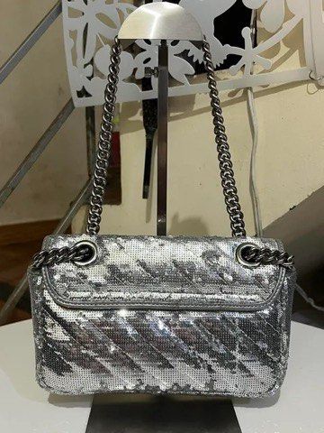 Gucci GG Marmont Silver Sequin Shoulder Bag (Category: Shoulder Bags) located in Quezon City. Submitted by luxuriesbymichiika (Listing ID 1464942872, Image 2). Description: - Authentic Gucci GG Marmont shoulder bag - Stunning all-over silver sequins with chevron quilting - Antique silver-tone hardware and iconic Double G clasp - Comfortable chain strap with leather shoulder reinforcement - Secure flap closure with push-lock mechanism - Clean grey