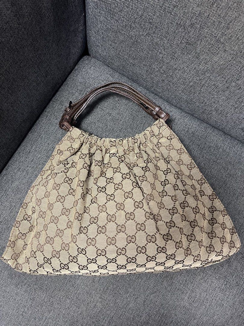 Gucci GG Monogram Canvas Hobo Shoulder Bag (Category: Shoulder Bags) located in General Trias. Submitted by mybag2025 (Listing ID 1464907283, Image 1). Description: Gucci hobo bag in classic beige and dark brown monogram canvas - Stylish gathered pleated body with a secure magnetic snap closure - Dark brown leather handles featuring adjustable buckle details - Spacious interior, perfect for carrying your daily essentials - Timeless design that ea