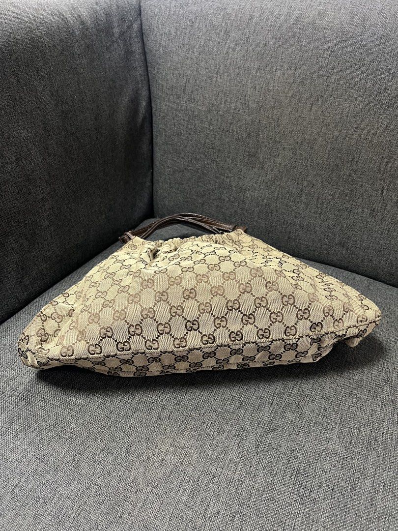 Gucci GG Monogram Canvas Hobo Shoulder Bag (Category: Shoulder Bags) located in General Trias. Submitted by mybag2025 (Listing ID 1464907283, Image 2). Description: Gucci hobo bag in classic beige and dark brown monogram canvas - Stylish gathered pleated body with a secure magnetic snap closure - Dark brown leather handles featuring adjustable buckle details - Spacious interior, perfect for carrying your daily essentials - Timeless design that ea