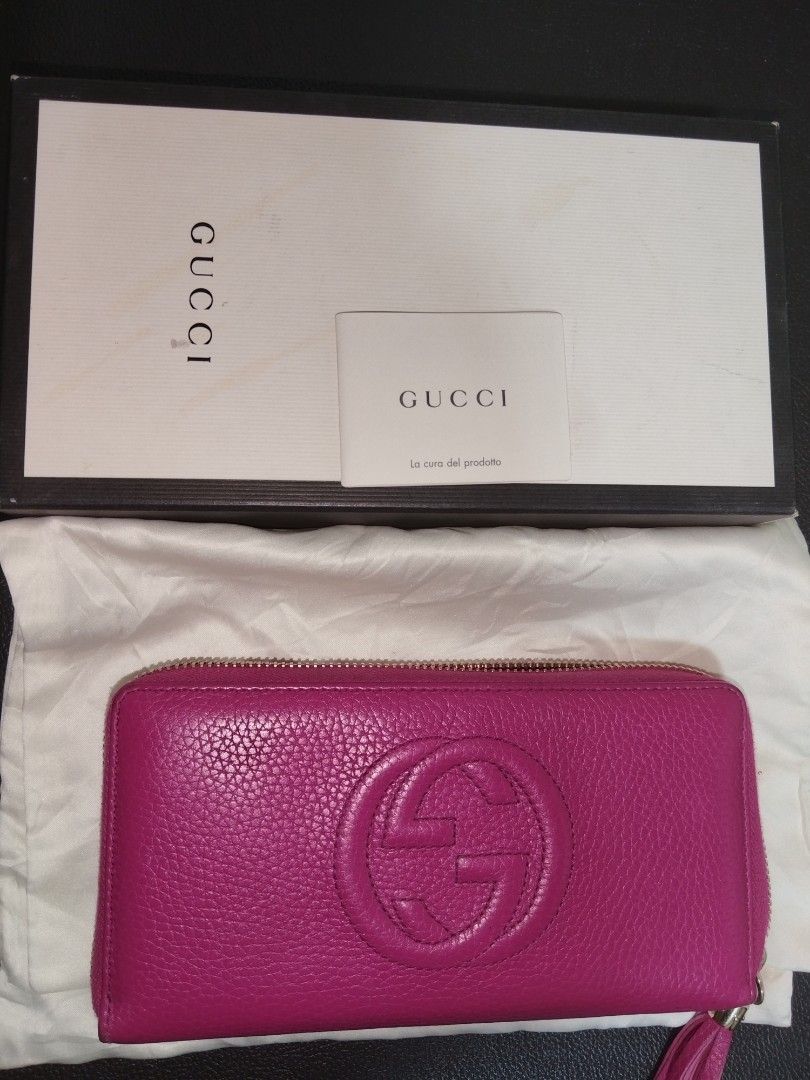 Gucci Soho Zip around wallet (w/ box) (Category: Luxury Bags & Wallets) located in Antipolo. Submitted by gievan0725 (Listing ID 1464854730, Image 3). Description: The highlighted item is a Gucci Soho Zip-Around Long Wallet. This iconic accessory is crafted from vibrant magenta/fuchsia pink pebbled leather and features the signature embossed interlocking GG logo centered on the front. Product Specifications • Brand: Gucci • Line: Soho Collection 