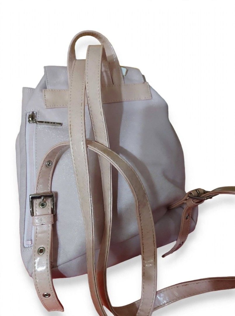 Guess light pink backpack (Category: Backpacks) located in Caloocan City. Submitted by chonadura91470 (Listing ID 1464778136, Image 3). Description: - Authentic Guess backpack in light pink - Features chic gold-tone GUESS plaque and hardware - Drawstring closure with secure magnetic snap - Adjustable patent leather-look straps and top handle - Handy zippered front pocket for small essentials - Flaw note: Shows noticeable rust stains near seams an