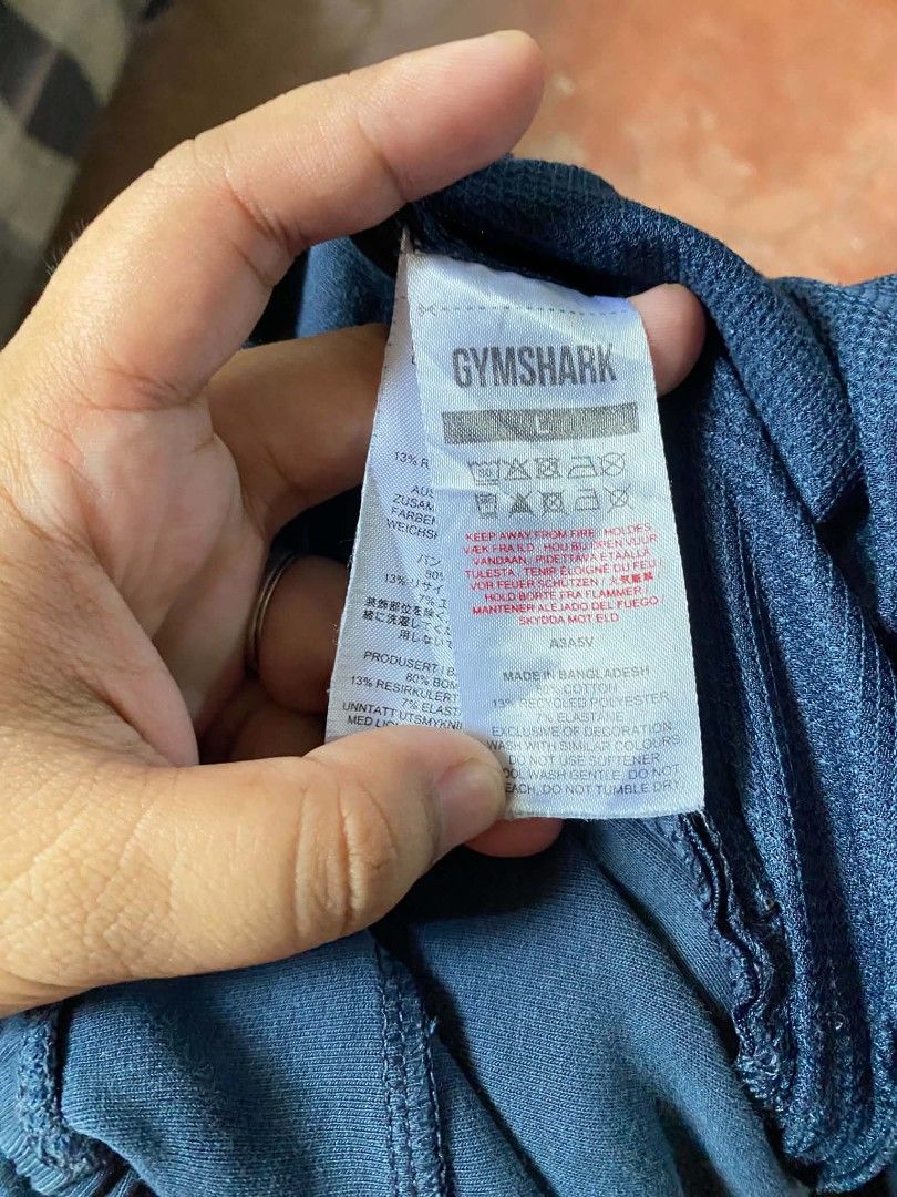 Gymshark Blue Joggers Size L (Category: Joggers) located in Gumaca. Submitted by makuliti (Listing ID 1464793630, Image 2). Description: - Brand/Model: Gymshark Blue Joggers - Size: Large - Material: 80% cotton, 13% recycled polyester, 7% elastane - Features: Adjustable drawstring waistband and secure zippered pockets on both sides - Condition: Good, with slight fabric fraying near one pocket zipper - Perfect for: Gym workouts or everyday casual 