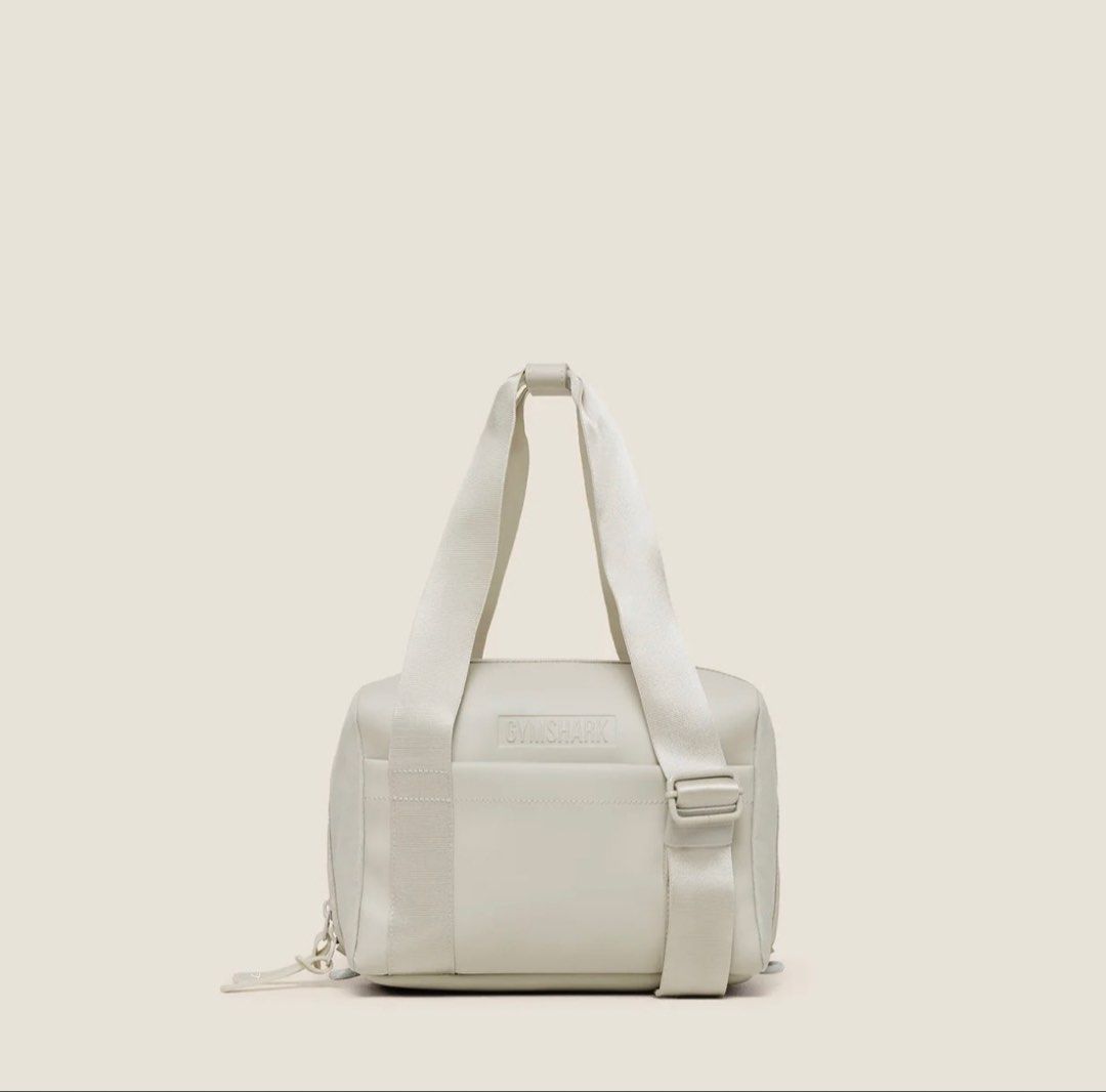 Gymshark Everyday Mini Holdall Bag Light Grey (Category: Activewear) located in Quezon City. Submitted by wshnm (Listing ID 1464901233, Image 1). Description: - Brand: Gymshark - Style: Everyday Mini Holdall - Color: Light Grey - Condition: Brand new, fresh out of packaging, untouched - Features: Durable webbed carry straps and embossed front logo - Perfect size for: Essentials, keys, phone, and small workout gear.