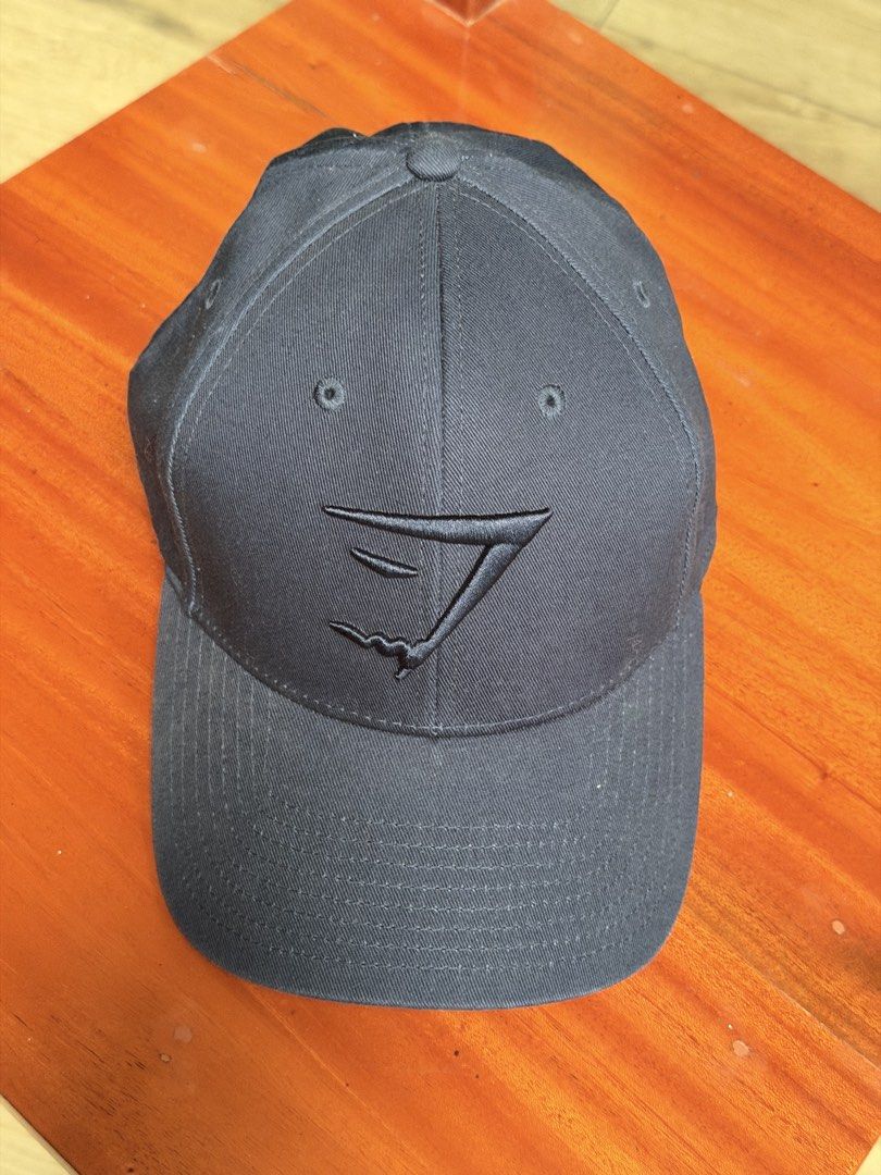 Gymshark Sharkhead Cap (Category: Caps & Hats) located in Iloilo. Submitted by caratdeul.17 (Listing ID 1464794467, Image 2). Description: - Authentic Gymshark baseball cap - Embroidered logo on the front - Classic curved brim and structured panels - Adjustable back strap for a custom fit - Available in Pink and Black - Ideal for gym sessions, workouts, and casual streetwear.