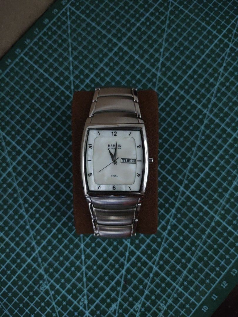 HAMLIN Ultra Thin Tank Watch Day Date Display (Category: Men's Watches) located in Mangatarem. Submitted by kacchon (Listing ID 1460184459, Image 1). Description: - Hamlin ultra-thin watch - Silver tone strap - Mother of Pearl Dial with day and date display at 3 o'clock - Classic rectangular case - American Watch - Integrated Bracelet with Complete Links - Negotiable Price.
