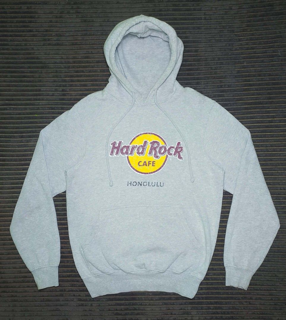 Hard Rock Cafe Honolulu Grey Hoodie Size Medium (Category: Coats, Jackets and Outerwear) located in Manila. Submitted by norathrifted (Listing ID 1464793356, Image 2). Description: - Authentic Hard Rock Cafe Honolulu hoodie in Grey - Size: Medium (tag attached) - Design: Classic distressed logo print in yellow and burgundy on the chest - Features: Front kangaroo pocket and adjustable drawstring hood - Material: Comfortable cotton and polyester bl
