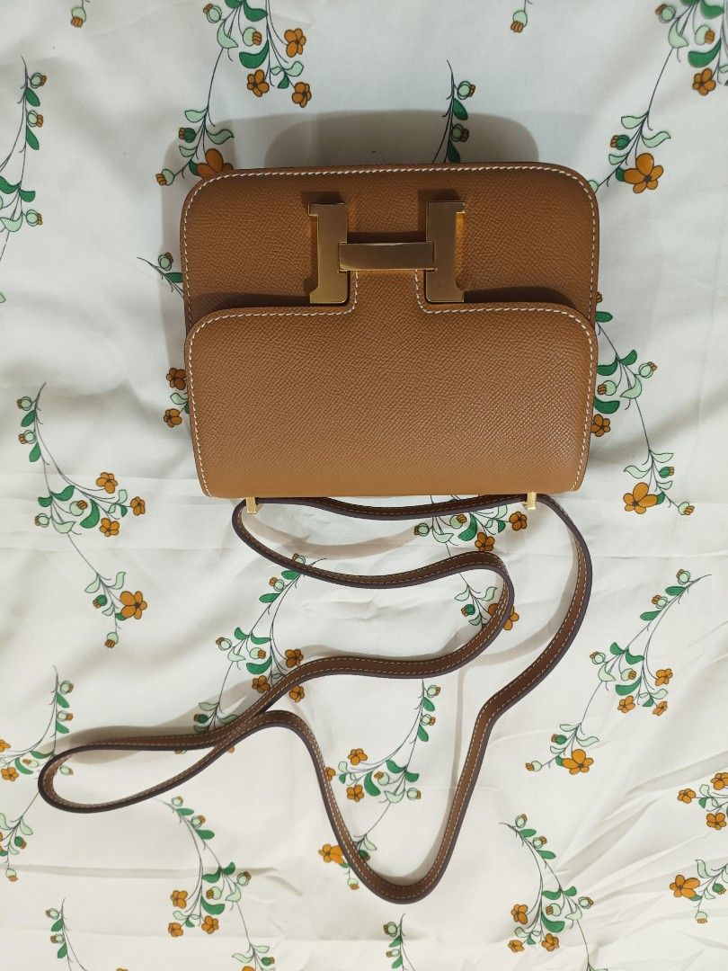 Hermes Constance Gold Epsom Leather Handbag (Category: Luxury Bags & Wallets) located in Baguio. Submitted by maria.s0329822318 (Listing ID 1464785791, Image 1). Description: - Brand: Hermes - Model: Constance - Material: Epsom leather - Color: Gold Brown (warm tan) - Hardware: Gold-tone H clasp and strap loops - Interior: Hermes Paris gold foil stamp - Details: Contrast white saddle stitching, adjustable shoulder strap, structured rectangular bo