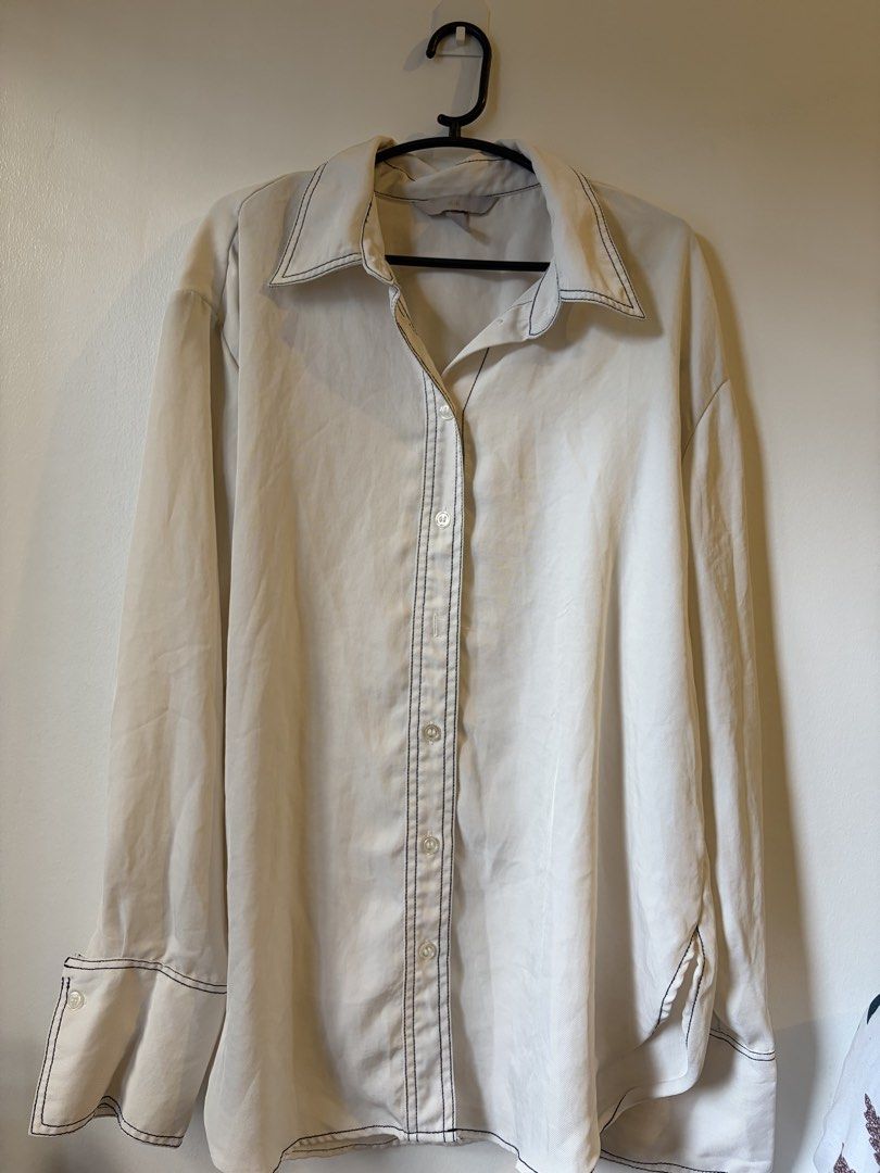 H&M contrast stitch button down shirt (Category: Longsleeves) located in Las Pinas. Submitted by bibliomomma (Listing ID 1464842495, Image 1). Description: Relaxed, oversized fit, button-down front, and wide folded cuffs for extra detail. Tagged size small, but designed with a roomy cut No photo when worn MOP Gcash.