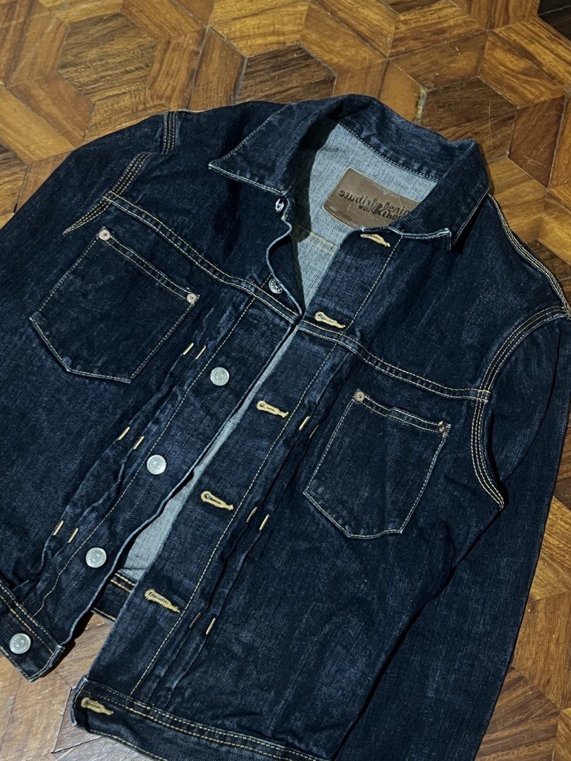 h&m Dark Wash Denim Jacket (Category: Coats, Jackets and Outerwear) located in Quezon City. Submitted by shadecluttersss (Listing ID 1464899193, Image 2). Description: - Style: Classic Type II denim jacket - Color/Wash: Dark indigo, clean dark wash with high fading potential - Material: Heavyweight rigid raw denim with leather neck patch - Details: Dual chest pockets, branded metal buttons, contrasting yellow stitching - Fit: Regular fit, perfect