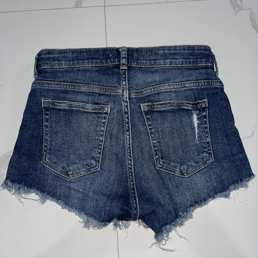 H&M Denim Cut-Off Shorts Size 2 (Category: Shorts) located in Manila. Submitted by amycol.ph (Listing ID 1464779134, Image 2). Description: - Brand/Style: H&M denim shorts in a classic dark blue wash - Size: EUR 32 / US 2 - Fit & Details: Mid-rise, zip fly with metal button, classic five-pocket styling - Edge: Raw frayed hems with subtle distressing on front and back pockets - Condition/Vibe: Super casual everyday piece that goes with everything 