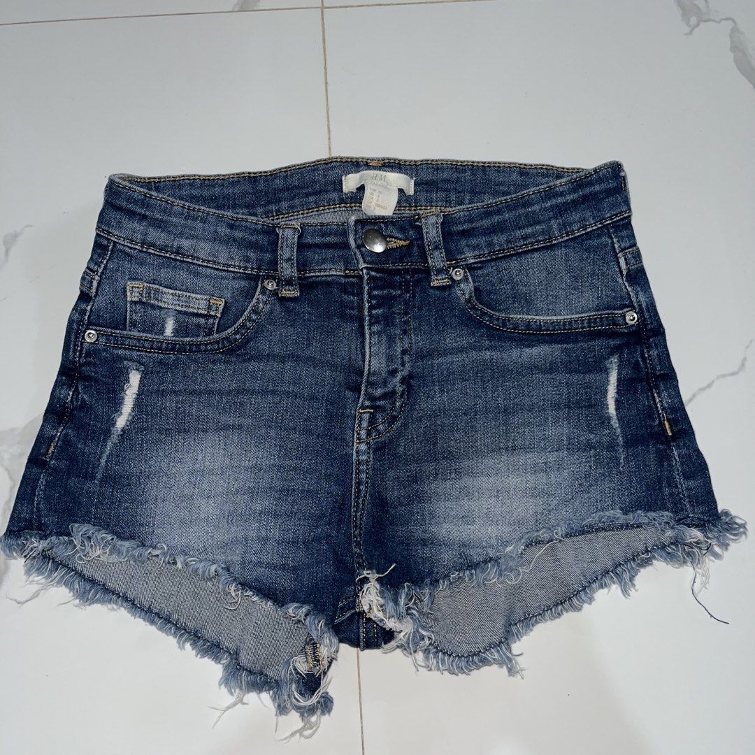 H&M Denim Cut-Off Shorts Size 2 (Category: Shorts) located in Manila. Submitted by amycol.ph (Listing ID 1464779134, Image 1). Description: - Brand/Style: H&M denim shorts in a classic dark blue wash - Size: EUR 32 / US 2 - Fit & Details: Mid-rise, zip fly with metal button, classic five-pocket styling - Edge: Raw frayed hems with subtle distressing on front and back pockets - Condition/Vibe: Super casual everyday piece that goes with everything 