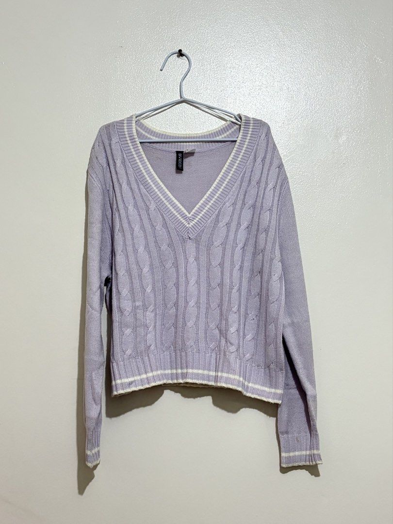 H&M Divided Purple Cable Knit V-Neck Sweater (Category: Longsleeves) located in Cainta. Submitted by knarv__ (Listing ID 1464882083, Image 1). Description: H&M Divided lilac cable knit sweater in size Medium. Features a V-neck collar, relaxed fit, and white striped trim on the collar, cuffs, and hem. Soft and cozy for layering..