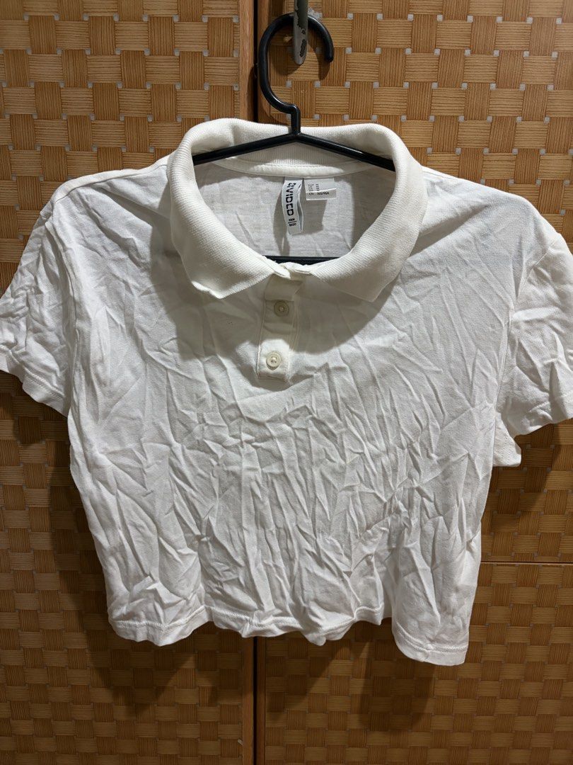H&M Divided White Crop Polo Top Size M (Category: Shirts) located in Pangil. Submitted by chel_anne (Listing ID 1464840874, Image 1). Description: - Brand/Model: H&M Divided white cropped polo shirt - Size: Medium (fits true to size) - Details: Short sleeves, pointed collar, two-button front placket - Material: Ribbed knit with stretch for comfort - Condition: Clean, pre-loved basic (needs a quick iron from storage) - Style: Perfect for effortles